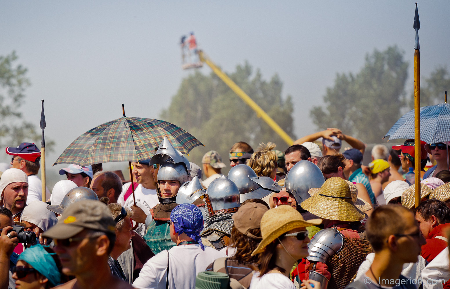Armored medieval knights among modern crowd of people