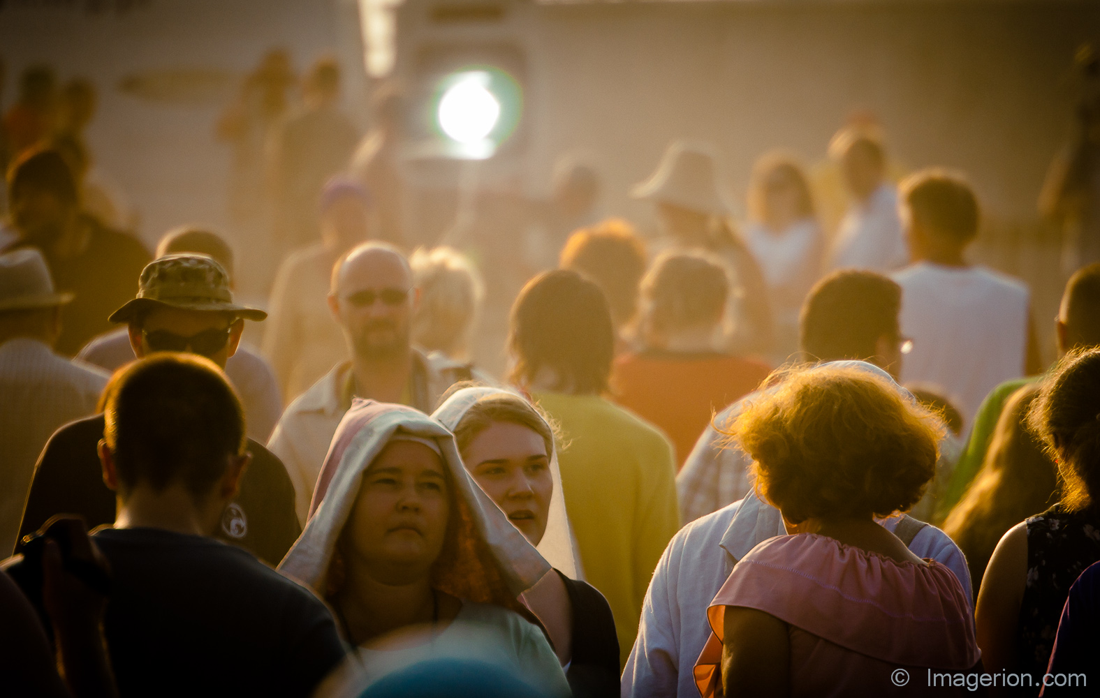 Modern crowd in a mist of dust and medieval women walking through